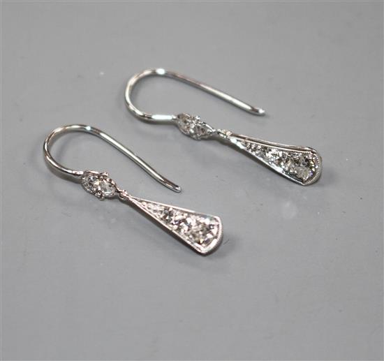 A pair of white metal and graduated diamond set fan-saped drop earrings, overall including ear wire 23mm, gross 1.1 grams.